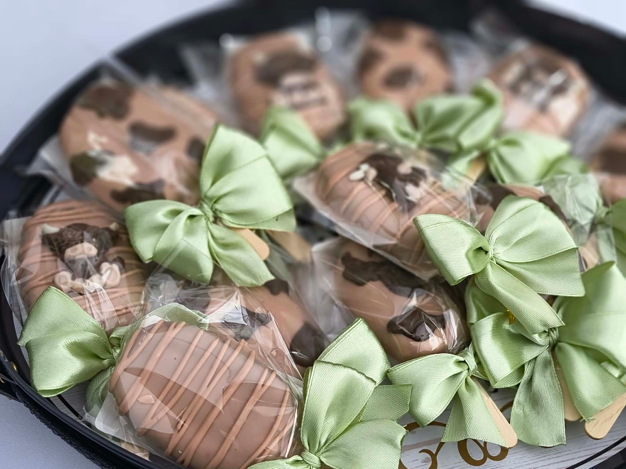 Chocolate covered strawberries with green ribbon bows