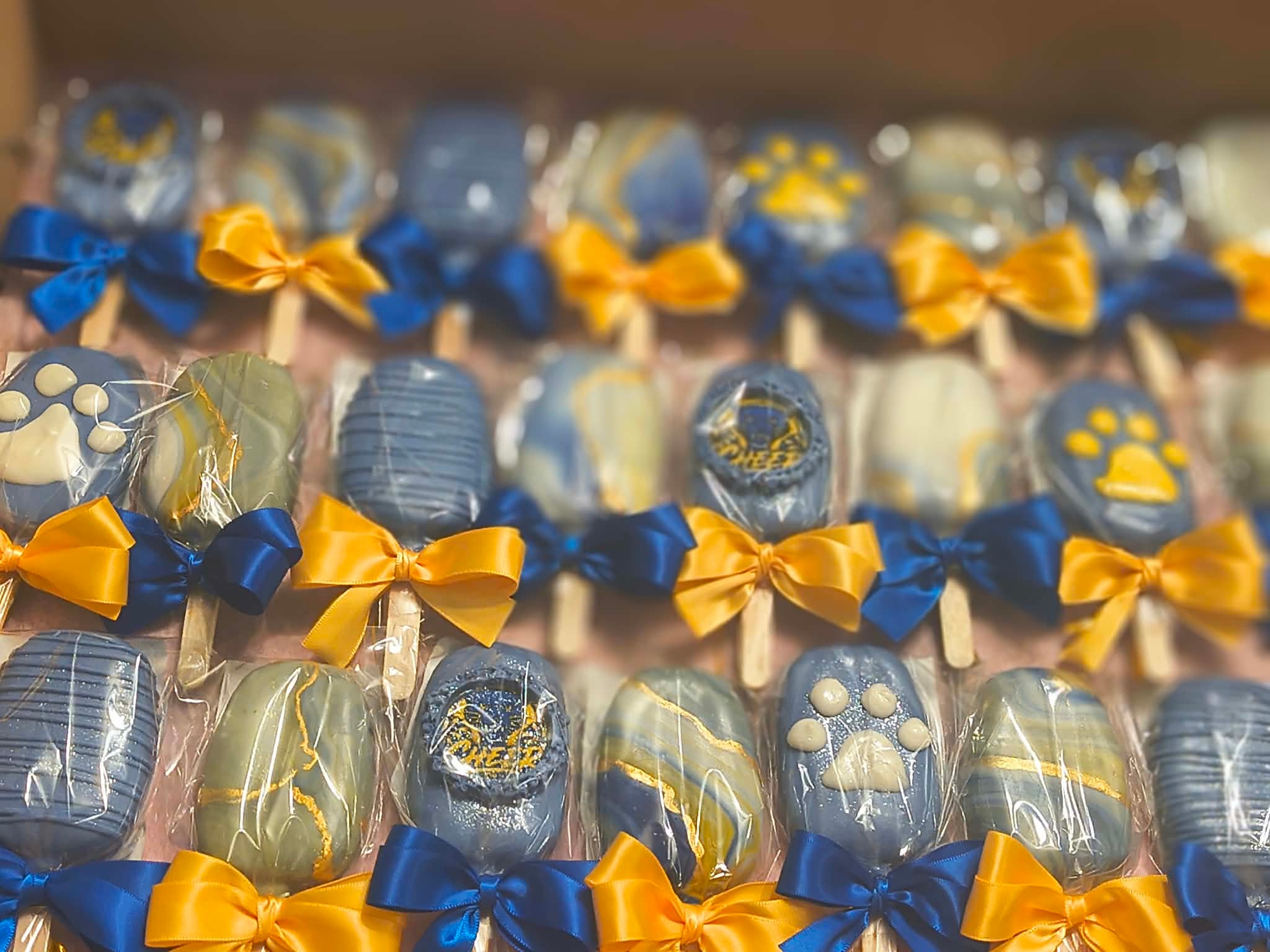 Decorated chocolate eggs with blue and yellow bows